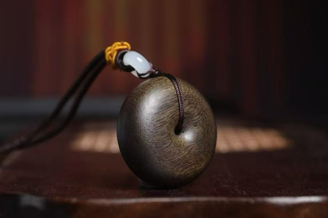 Brunei agarwood peace buckle pendant front view